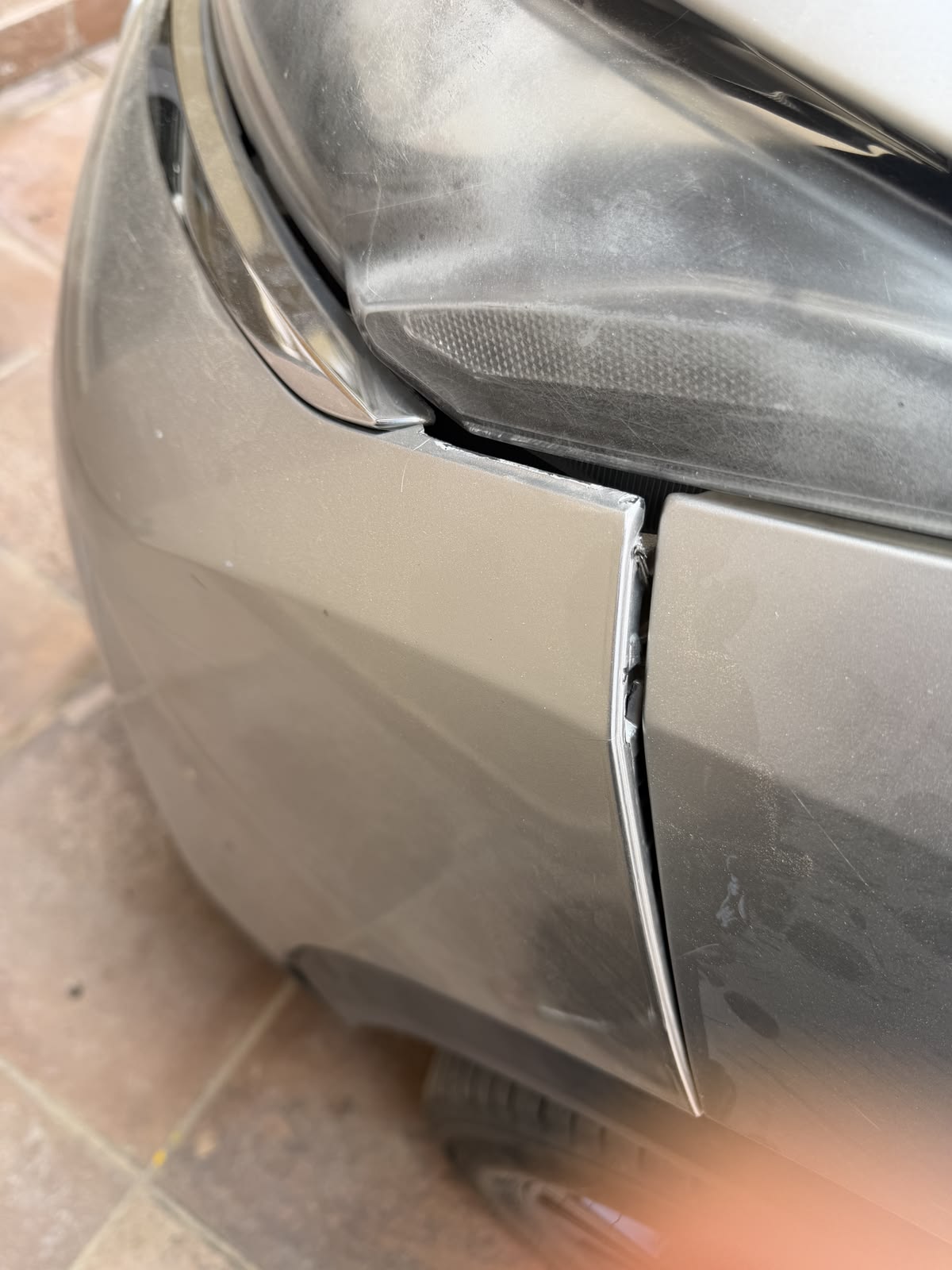 Close-up of a car panel showing a minor crease